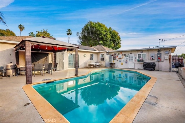 view of pool with a gazebo, grilling area, and a patio area