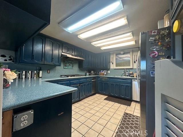 kitchen featuring sink, light tile patterned floors, and appliances with stainless steel finishes