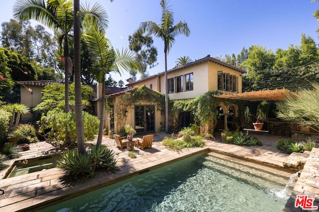 rear view of property featuring a patio