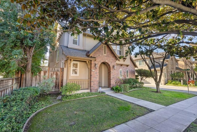 english style home featuring a front lawn