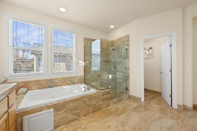 bathroom with vanity and independent shower and bath