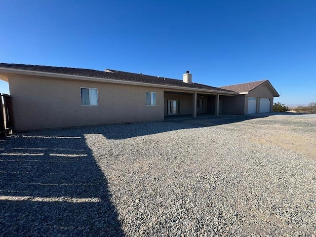 rear view of house with a garage