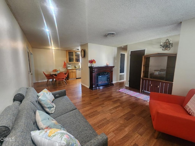 living room featuring a textured ceiling and dark hardwood / wood-style floors