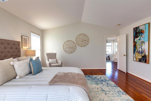 bedroom featuring dark hardwood / wood-style flooring and lofted ceiling