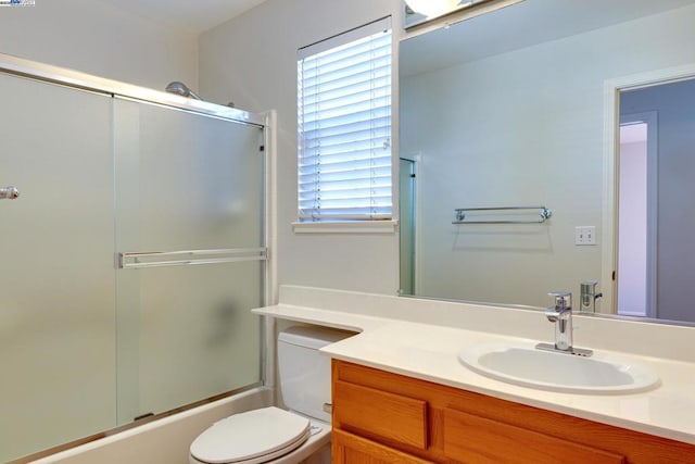 full bathroom featuring toilet, vanity, and combined bath / shower with glass door