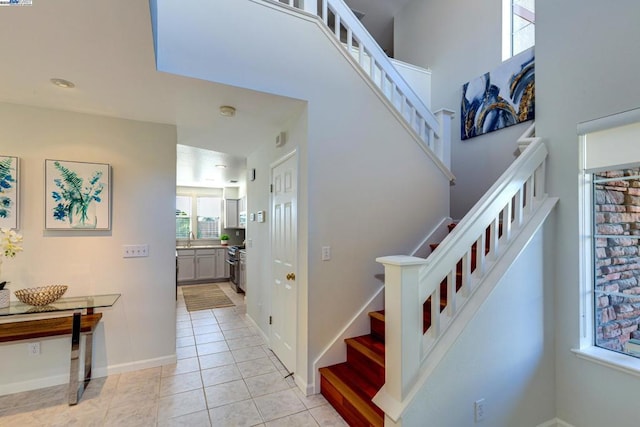 staircase with sink and tile patterned floors