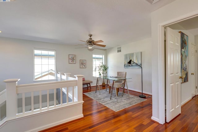 dining room with ceiling fan and dark wood-type flooring