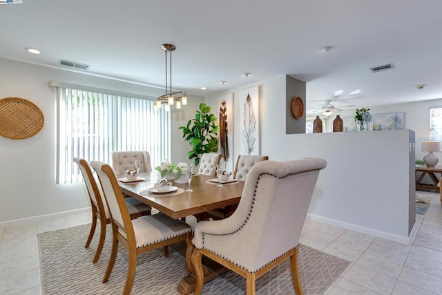 dining area with a healthy amount of sunlight, light tile patterned floors, and ceiling fan