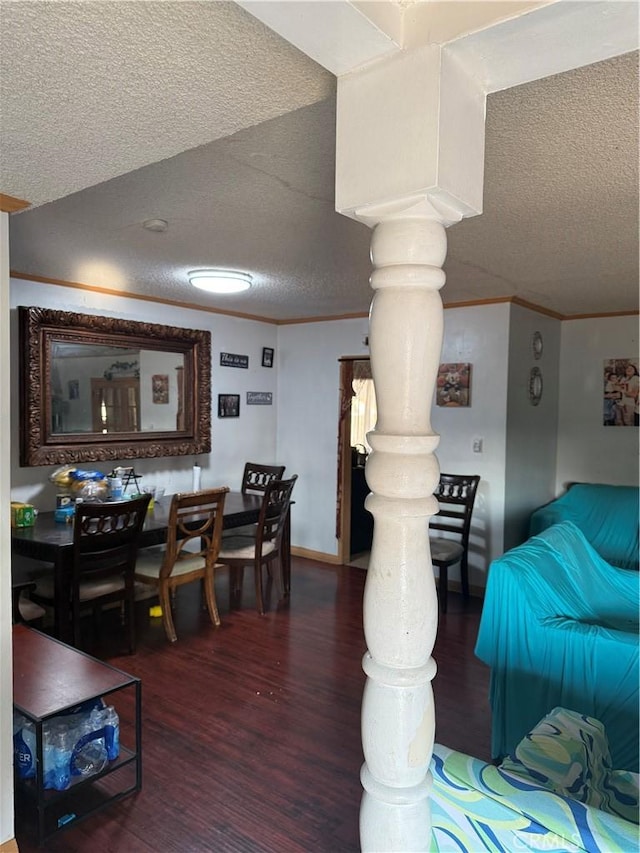 living room featuring crown molding, a textured ceiling, and dark hardwood / wood-style flooring