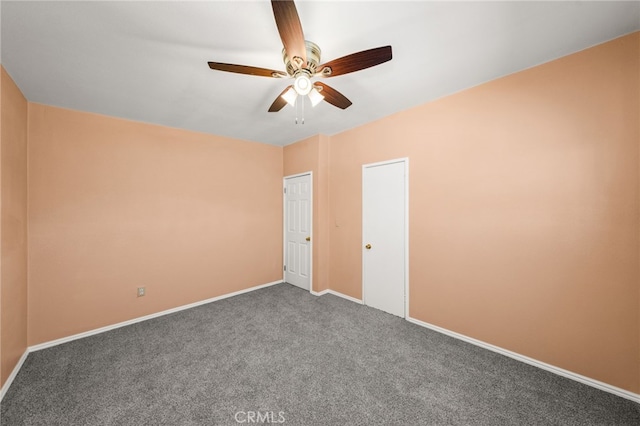 carpeted spare room with ceiling fan