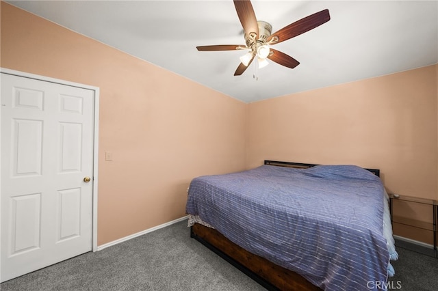 bedroom with ceiling fan and dark colored carpet