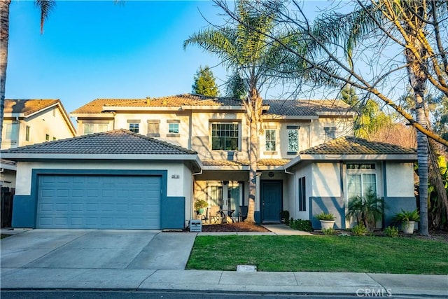 view of front of house with a front yard and a garage