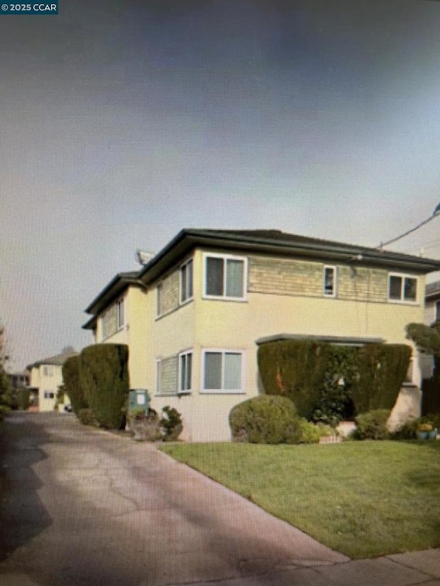 view of side of home with a lawn