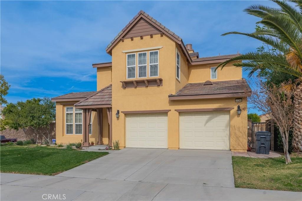 view of front of property with a garage and a front lawn