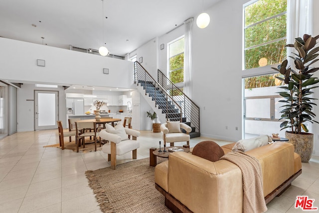 living room featuring light tile patterned flooring and a high ceiling