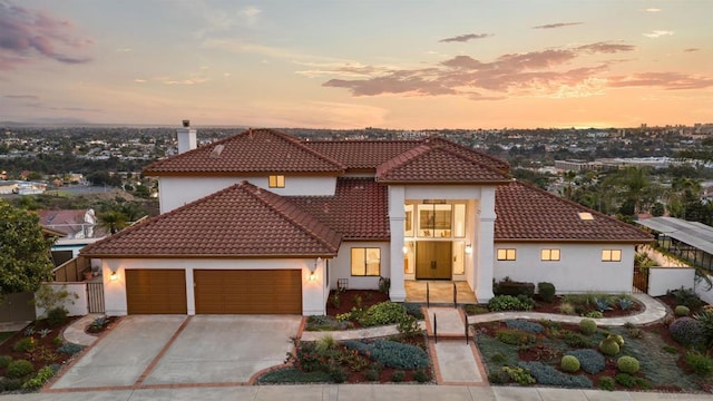 mediterranean / spanish-style house with a garage