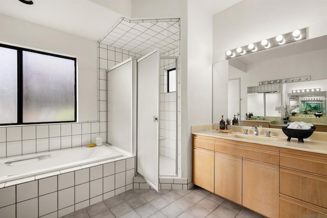 bathroom featuring tile patterned flooring, vanity, and independent shower and bath