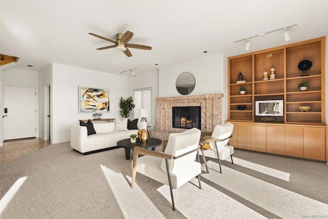 carpeted living room featuring ceiling fan and rail lighting