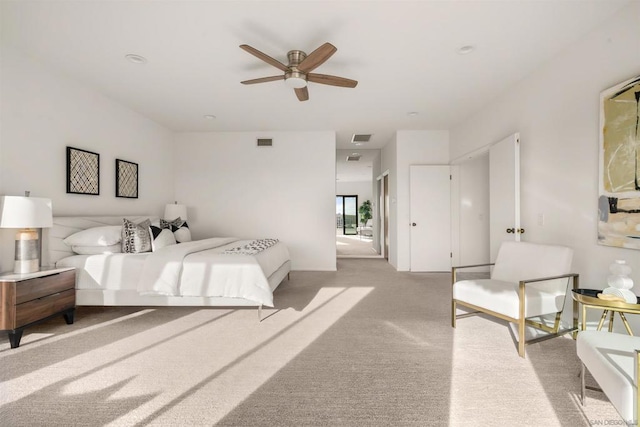 bedroom featuring light carpet and ceiling fan