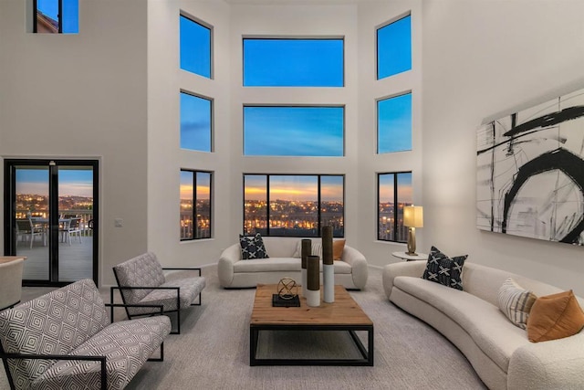 carpeted living room with a towering ceiling