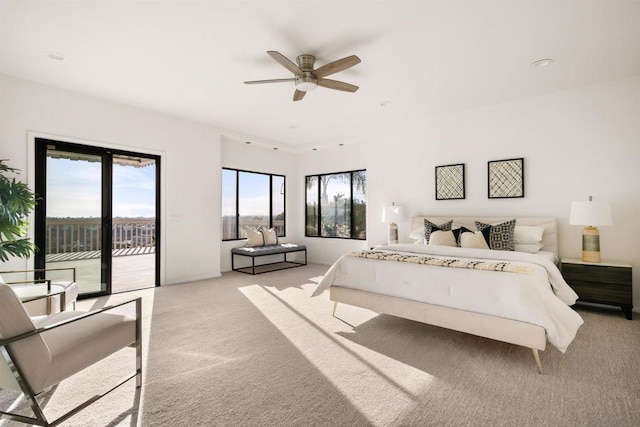 bedroom featuring light carpet, access to exterior, and ceiling fan