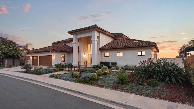 mediterranean / spanish-style home with a garage