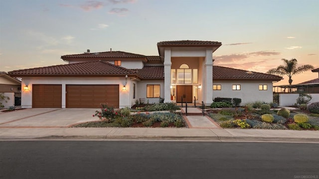 mediterranean / spanish home featuring a garage