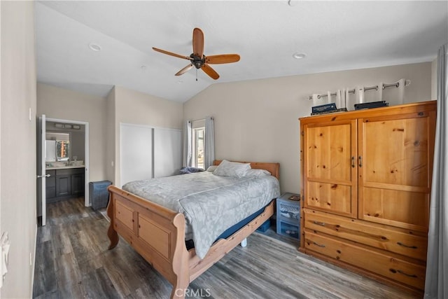 bedroom with connected bathroom, vaulted ceiling, dark hardwood / wood-style floors, a closet, and ceiling fan