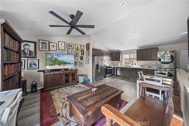 living room featuring ceiling fan, lofted ceiling, sink, and dark hardwood / wood-style flooring