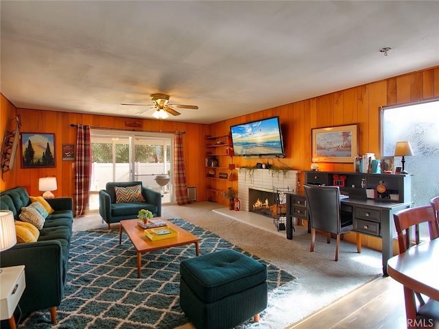 living room featuring wood walls and ceiling fan