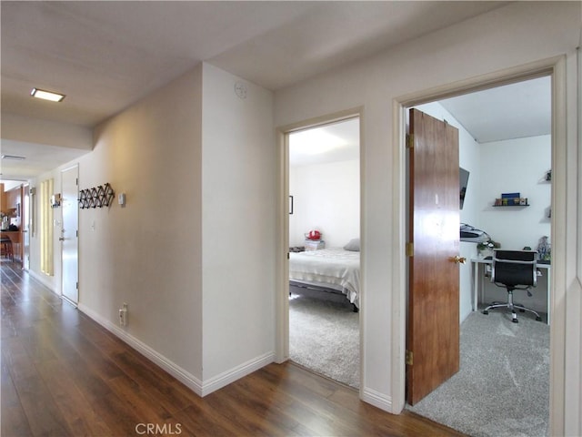 hallway with dark hardwood / wood-style floors