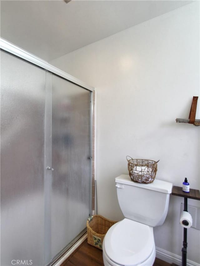 bathroom with wood-type flooring and toilet