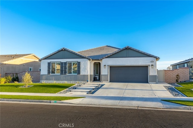 ranch-style house with a garage and a front yard