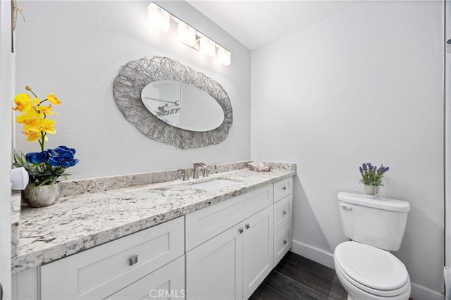 bathroom featuring vanity and toilet