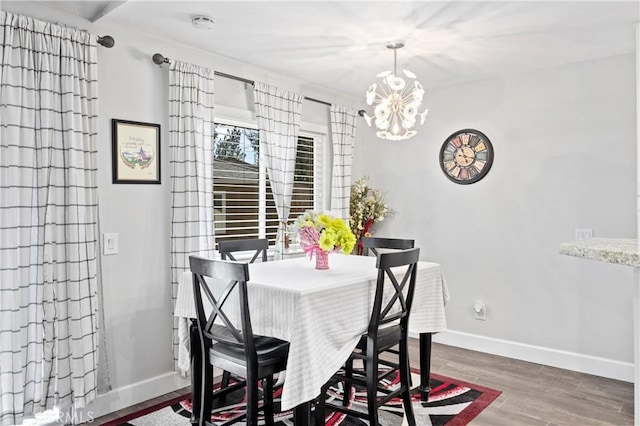 dining area featuring hardwood / wood-style flooring and a chandelier