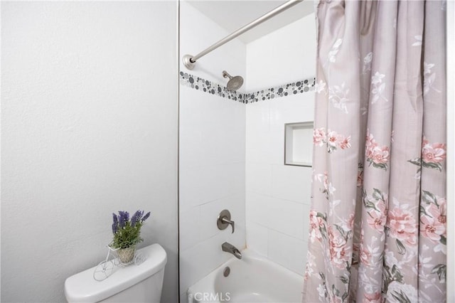 bathroom with shower / bathtub combination with curtain and toilet