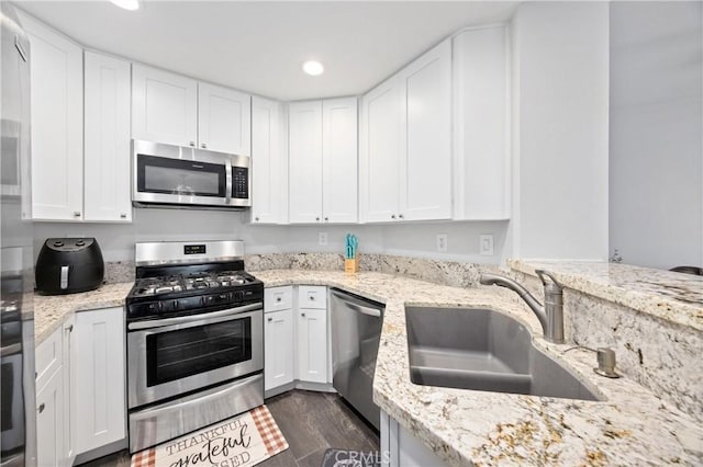 kitchen featuring white cabinetry, stainless steel appliances, dark hardwood / wood-style floors, and sink