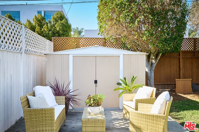 view of patio / terrace featuring an outdoor living space and a storage shed