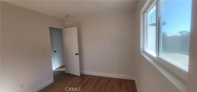 empty room with dark hardwood / wood-style floors