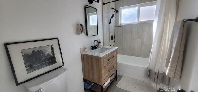 full bathroom featuring vanity, shower / tub combo, and toilet