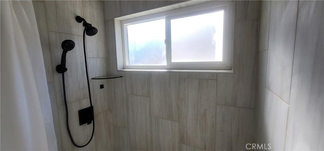 bathroom with tiled shower