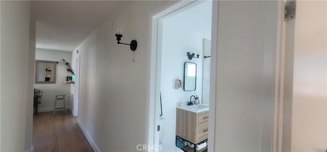 hall with dark hardwood / wood-style floors and sink