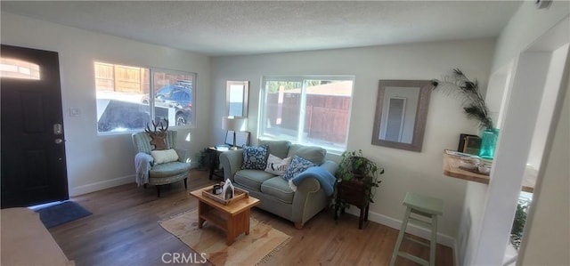 sitting room with hardwood / wood-style floors and a textured ceiling