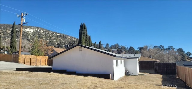 view of property exterior featuring a mountain view