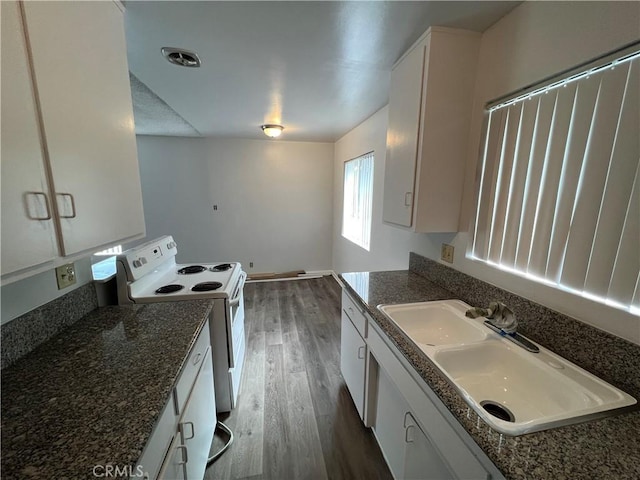 kitchen featuring sink, dark wood-type flooring, white cabinets, and white range with electric cooktop