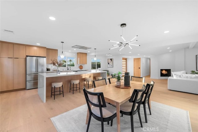 dining area featuring sink and light hardwood / wood-style flooring