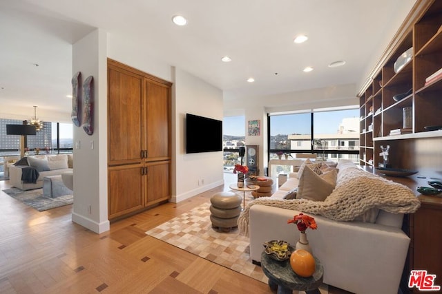 living room featuring a notable chandelier and light parquet flooring