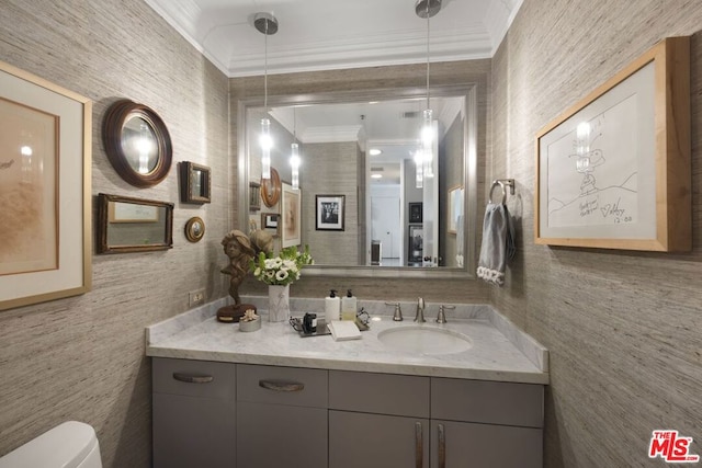 bathroom with vanity, toilet, and crown molding