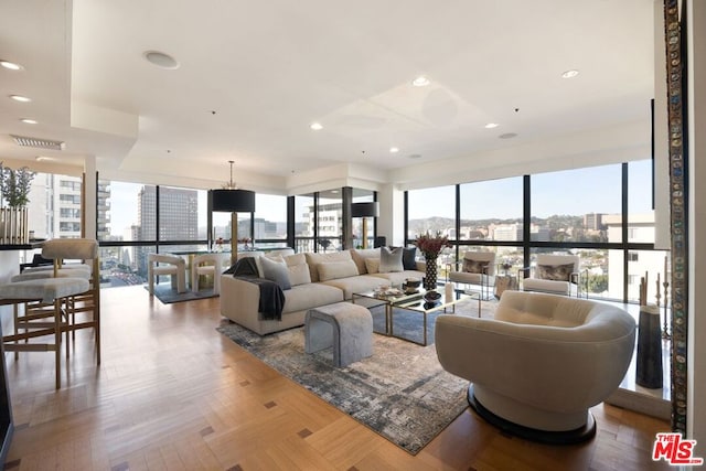 living room with light parquet floors, expansive windows, and a wealth of natural light