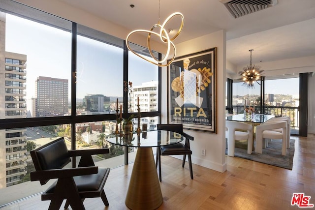 dining room featuring light parquet floors and a notable chandelier